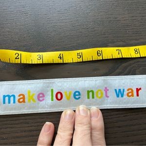 BNWT Blue Q “Make Love Not War” wristband
